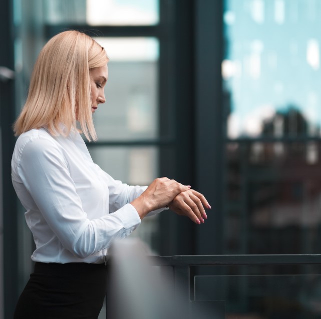 A photo of a Woman checking her wristwatch